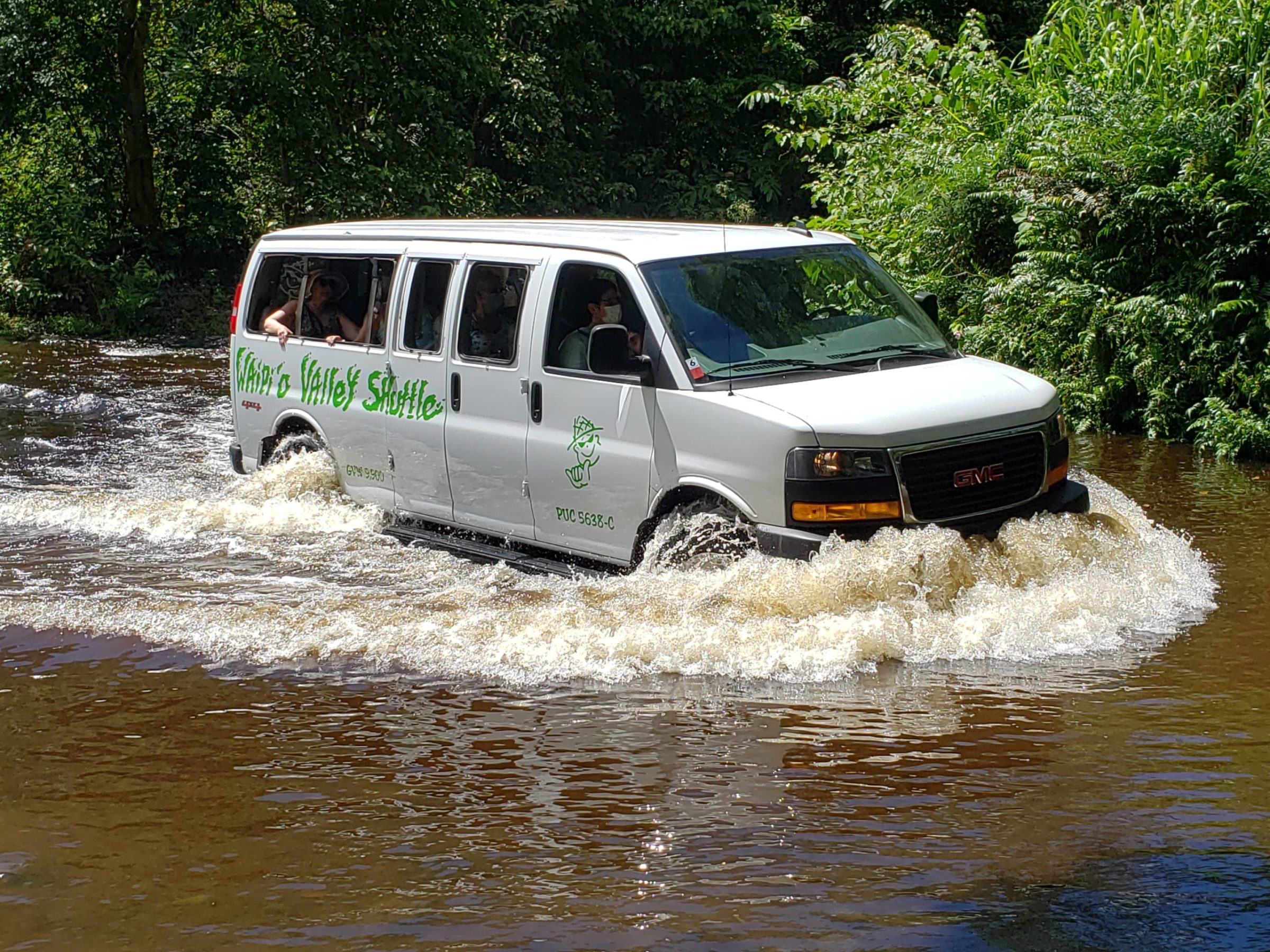 The Waipio Valley Shuttle driving through water