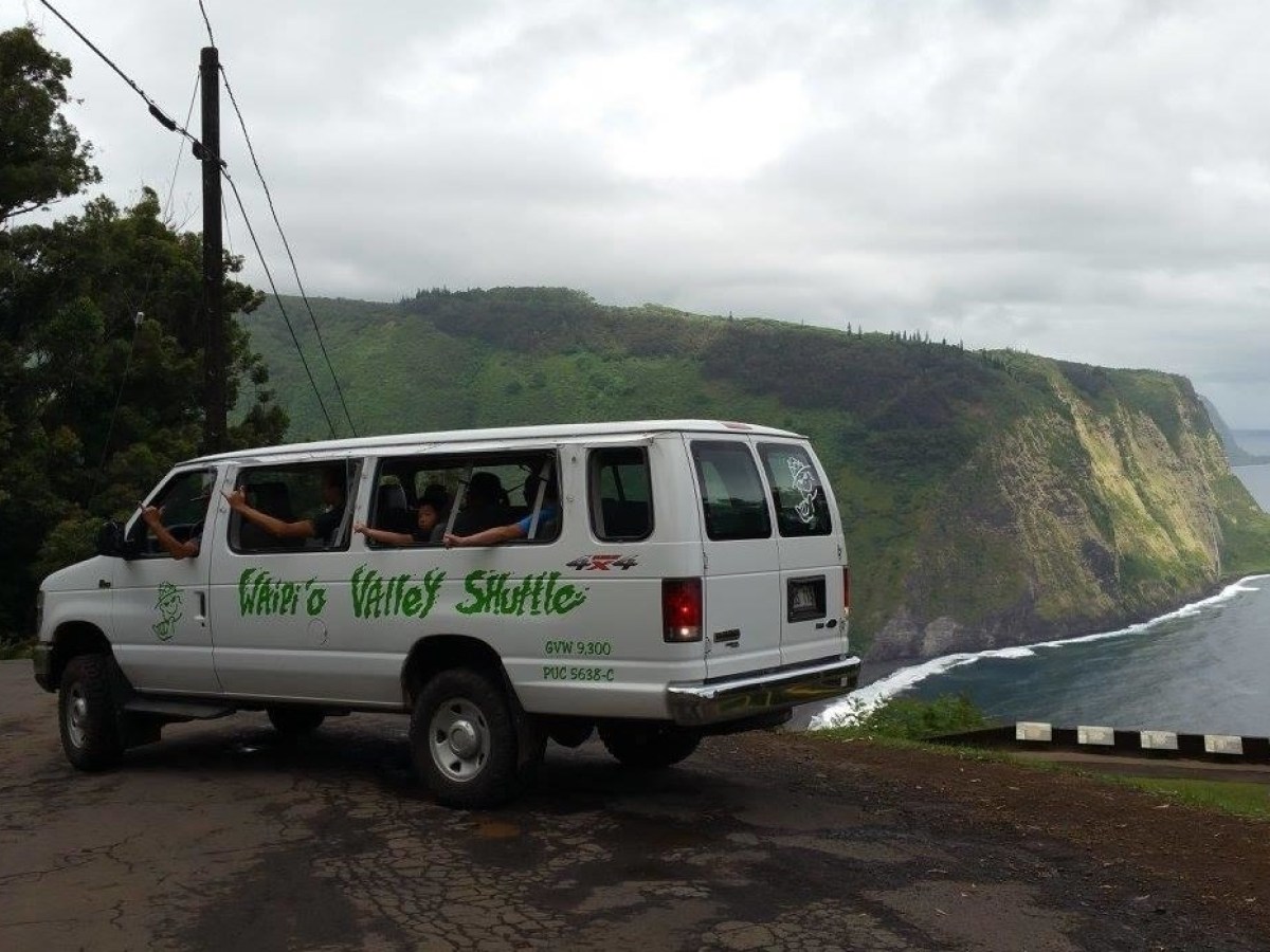 a van driving down a dirt road