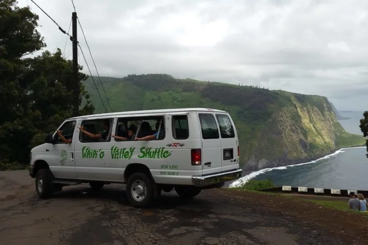 a van driving down a dirt road